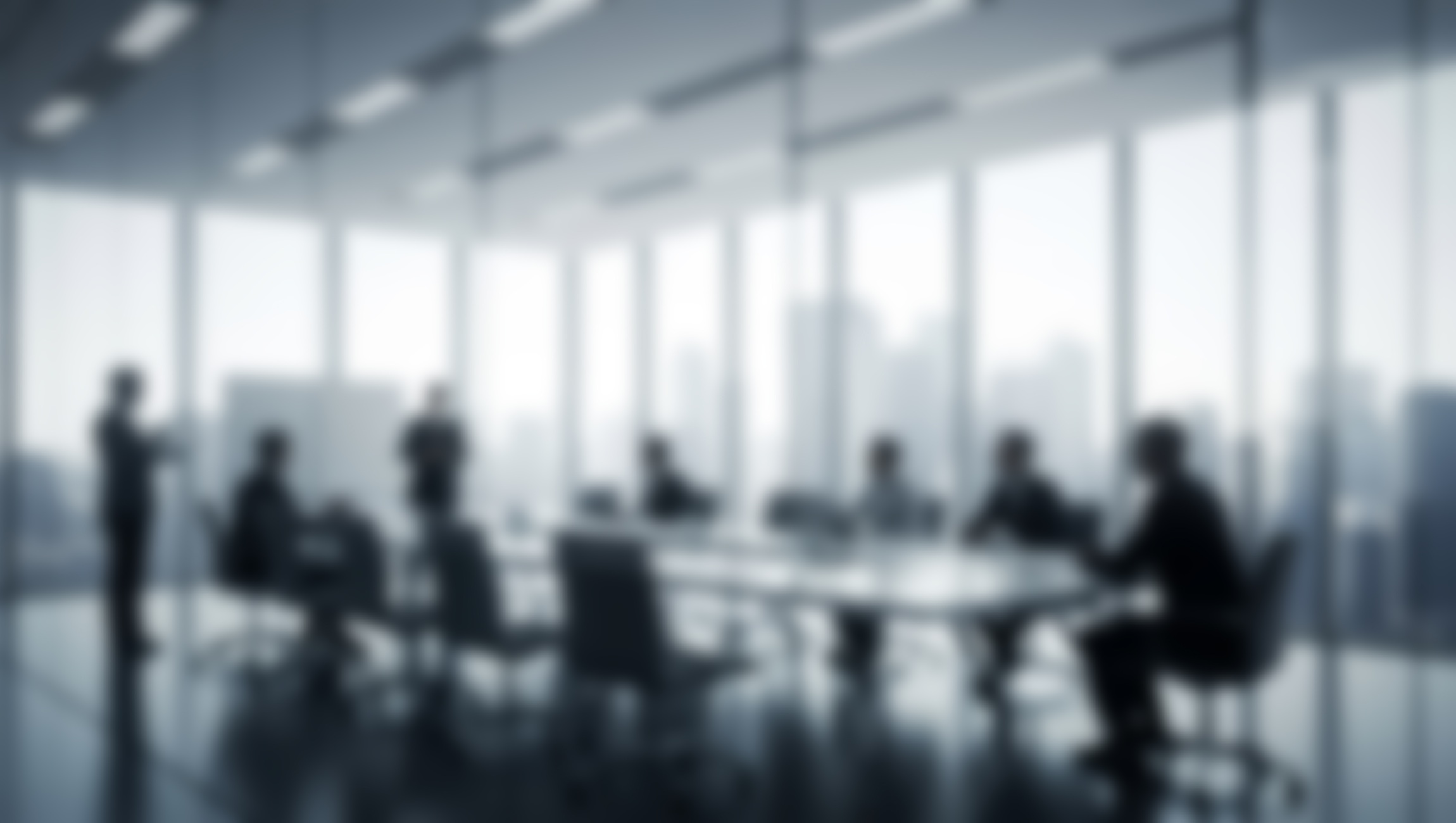 Blurred modern law office with professionals in a meeting room, symbolizing the rise of hybrid roles, Legal Tech, and digital transformation in law firms.